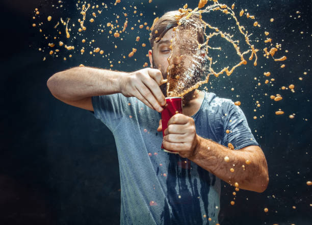 istock Man drinking a cola and enjoying the spray. 1144349157