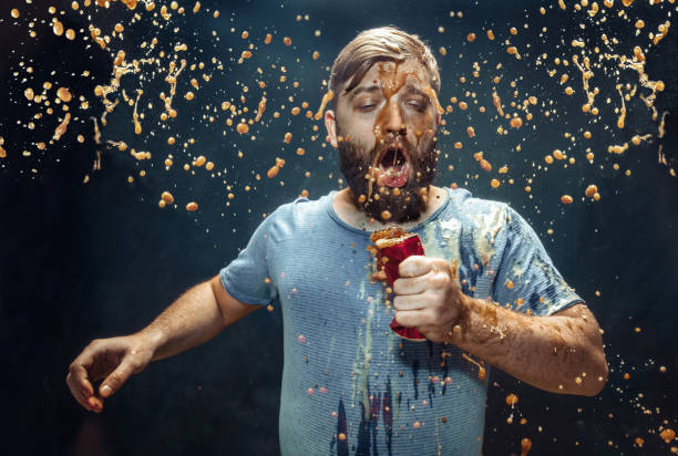 istock Man drinking a cola and enjoying the spray. 1144349164