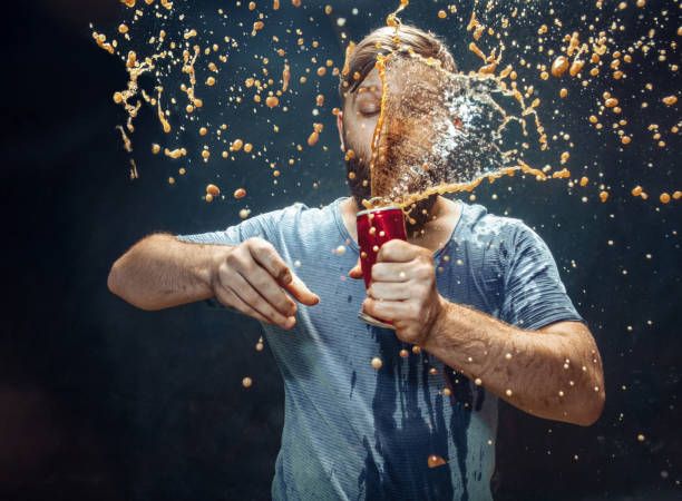 istock Man drinking a cola and enjoying the spray. 1144349170