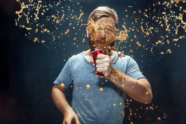 istock Man drinking a cola and enjoying the spray. 1144349172