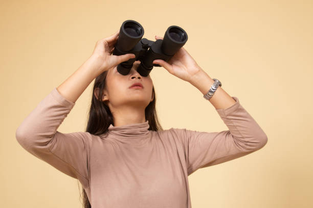istock Young Asian woman with binoculars. 1144351066