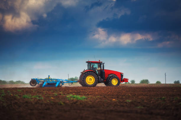 istock Farmer in tractor preparing land with seedbed cultivator 1144351851