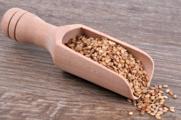 istock Sesame seeds in a wooden spoon 1144353632