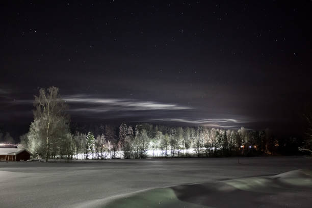 istock Low clouds illuminated by street lights and starry sky 1144353726