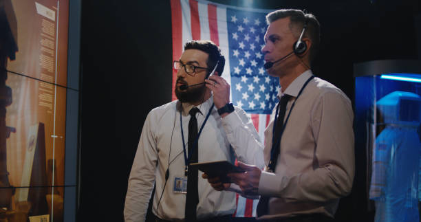 two technicians watching screen in control room - ground crew audio imagens e fotografias de stock