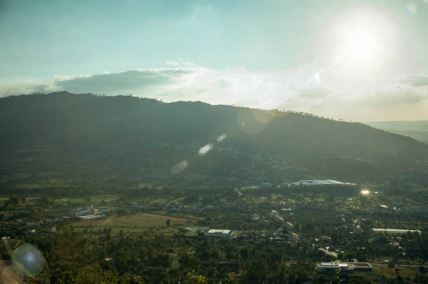 istock Wooded valley with a small village on sunset 1144353912