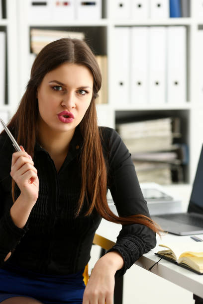 istock Beautiful smiling girl at workplace hold silver pen 1144354213