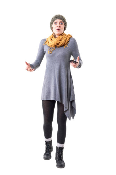 istock Surprised expression amazed young stylish hipster woman holding mobile phone looking at camera 1144355138
