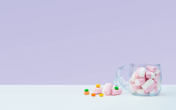 istock Marshmallow with dragee next to the glass open transparent jar and in it 1144357542