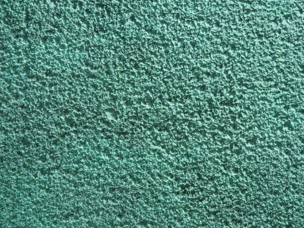 istock Coarse plaster painted green with a porous texture background 1144357570