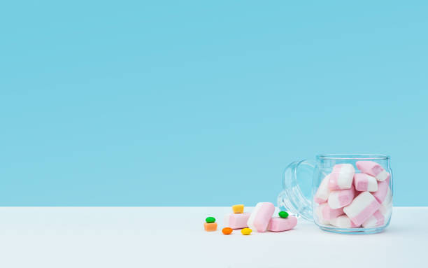 istock Marshmallow with dragee next to the glass open transparent jar and in it 1144357619