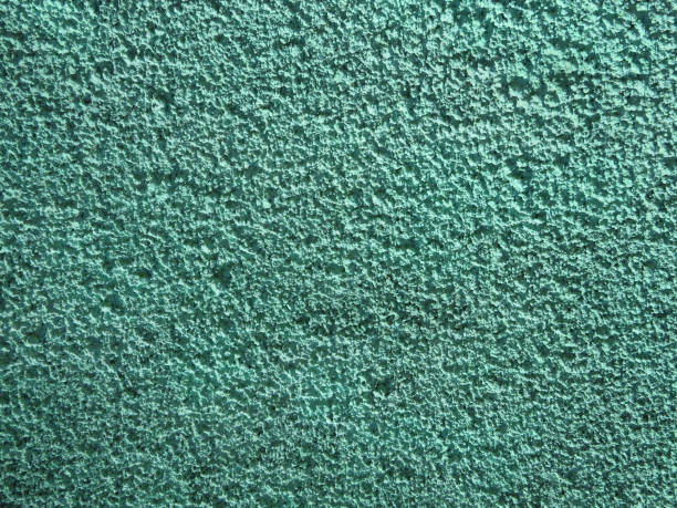 istock Coarse plaster painted green with a porous texture background 1144357656