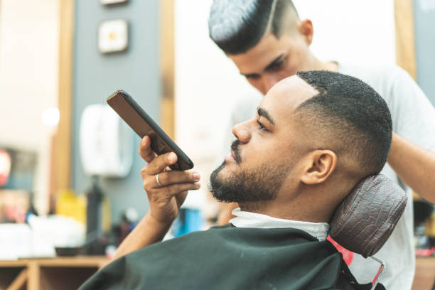 istock Man sending voice message in barbershop 1144357895