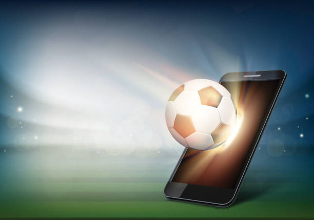 istock Smartphone on soccer field. Ball on the football stadium 1144357931