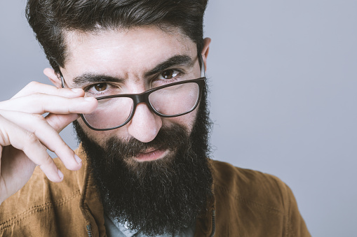 Young hipster man with glasses and beard.