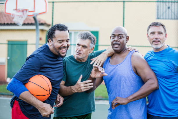istock Multi-ethnic group of middle aged men playing basketball 1144359453