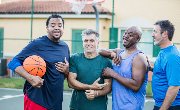 istock Multi-ethnic group of middle aged men playing basketball 1144359516