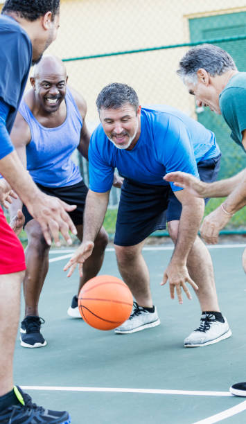 istock Mature men having fun playing basketball 1144361010