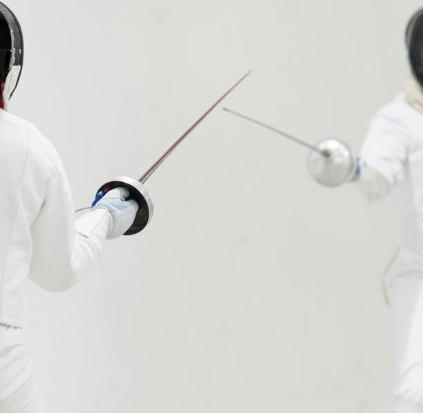 istock Two Professional Fencers Show Masterful Swordsmanship in their Foil Fight. 1144362443