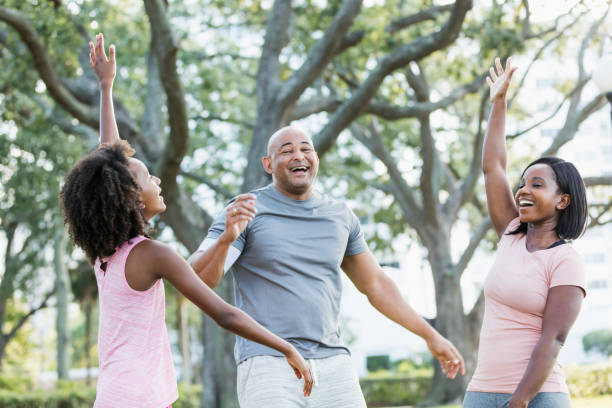 istock Girl and her parents having fun in park 1144362553