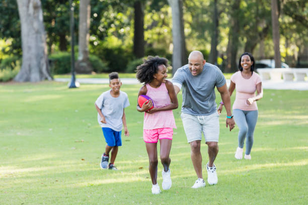 istock Interracial family with two children having fun in park 1144364155