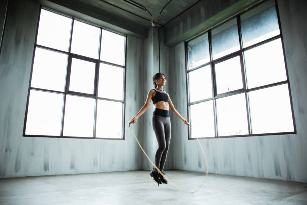istock woman jumping rope in the gym 1144366383