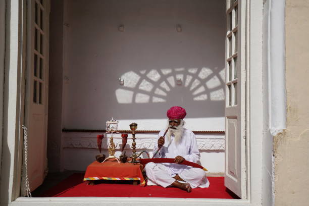 JAIPUR, INDIA - OCT 19, 2012: Indian guard with red turban in the City Palace in Jaipur,India. The palace is still the seat of the Maharaja of Jaipur, the head of the Kachwaha Rajput clan.