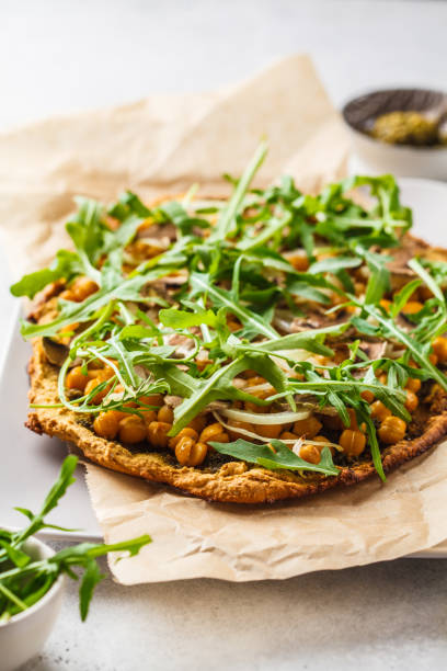 istock Green vegan pizza with pesto, chickpeas, champignons and arugula. 1144367542