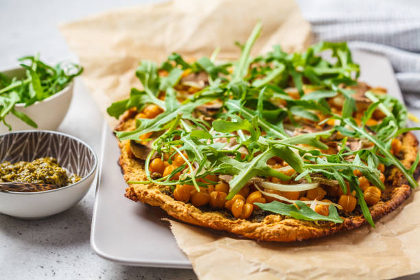 istock Green vegan pizza with pesto, chickpeas, champignons and arugula. 1144367569