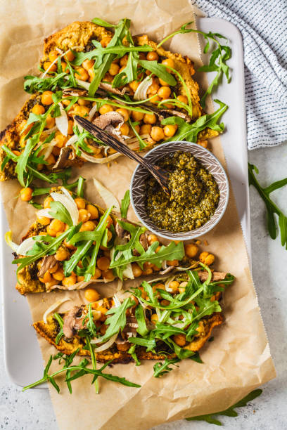 istock Green vegan pizza with pesto, chickpeas, champignons and arugula. 1144367850