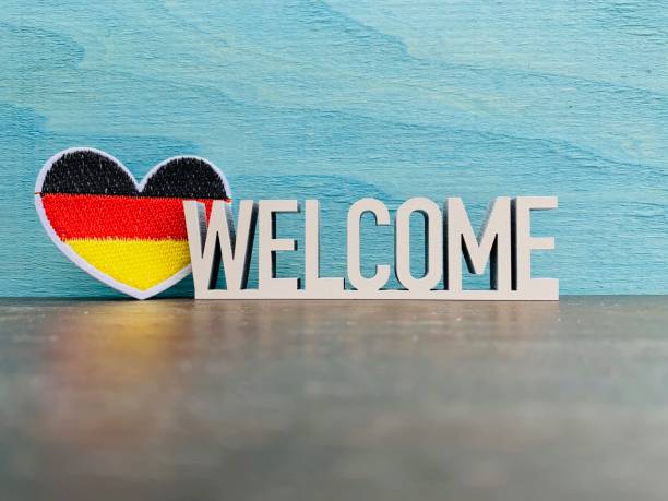 istock German flag and welcome sign on blue background 1144368781