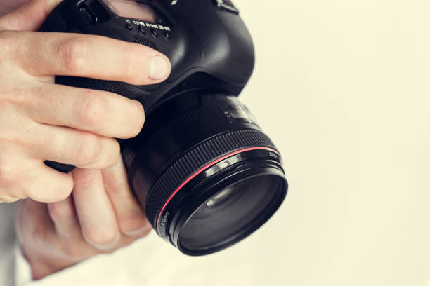 istock photographer with camera in hand 1144368855