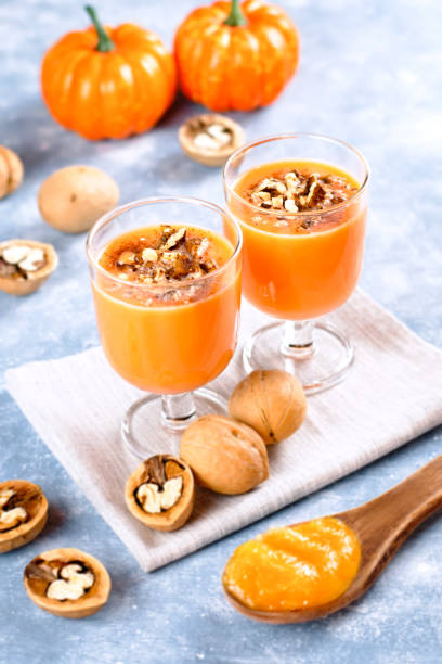 istock Healthy pumpkin smoothie with walnuts and cinnamon in glasses on rustic background 1144369793