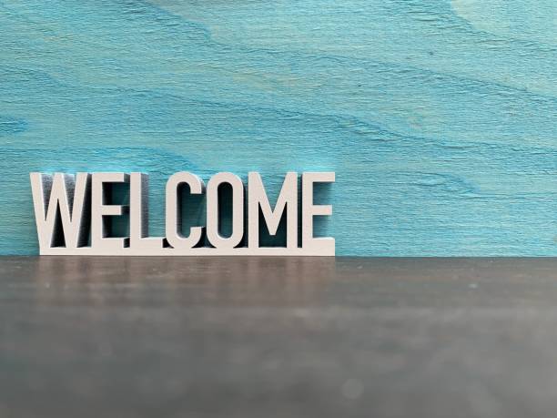 Welcome sign on blue background stock photo