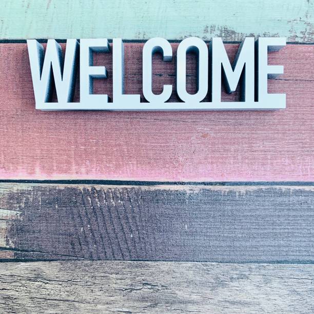 istock Welcome sign on colourful striped background 1144370416