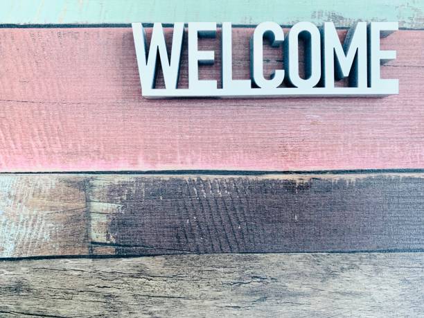 istock Welcome sign on colourful striped background 1144370451