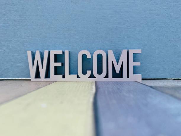 istock Welcome sign on colourful striped background 1144370480