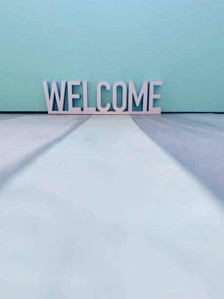 istock Welcome sign on colourful striped background 1144370498
