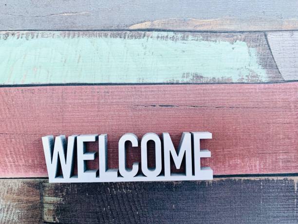 istock Welcome sign on colourful striped background 1144370555