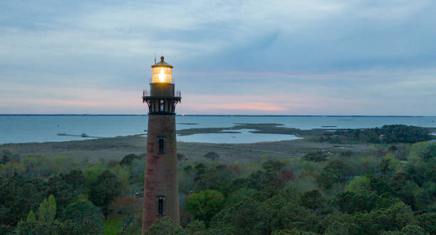 sun setting en currituck lighthouse outer banks north carolina - fresnel fotografías e imágenes de stock