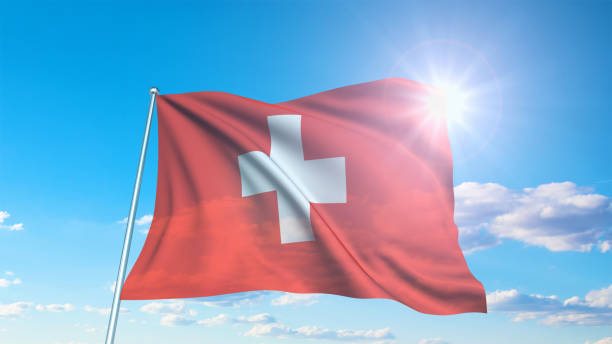 istock flag of Switzerland with fabric structure against a cloudy sky 1144371902