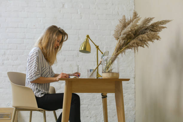 istock woman is handwriting at the table 1144371907