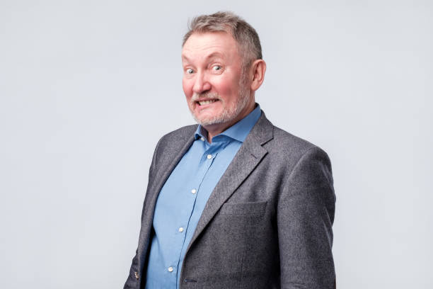 istock man thinking looking with tricky facial emotion. 1144372084
