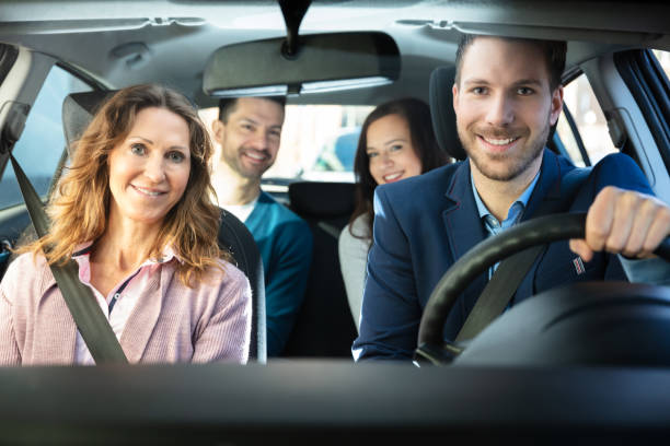 Smiling People Sitting In Car Group Of Happy Friends Having Fun In The Car car pooling stock pictures, royalty-free photos & images