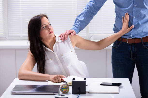 istock Woman Defending Herself From Sexual Harassment By Boss 1144374086