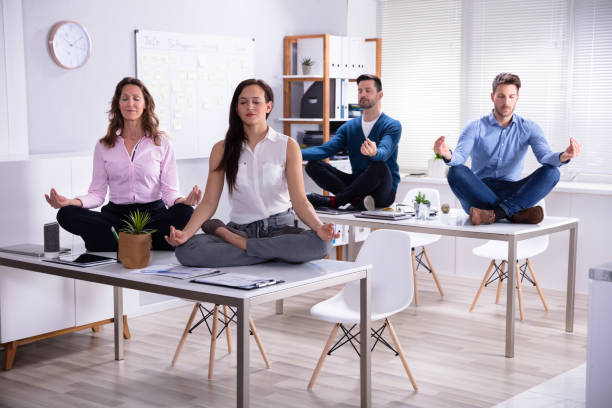 istock Businesspeople Meditating In Office 1144374126