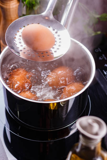 istock young woman in an gray apron boiled eggs 1144374265