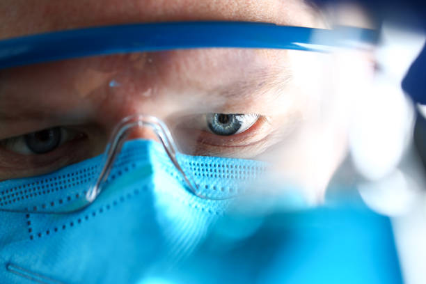 Chemistry man wearing protective mask hold in hand test sample
