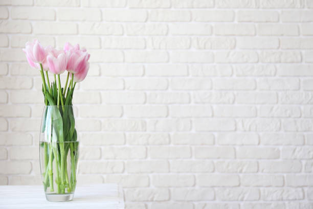istock Lofty interior with flowers in glass vase on the table. 1144377588