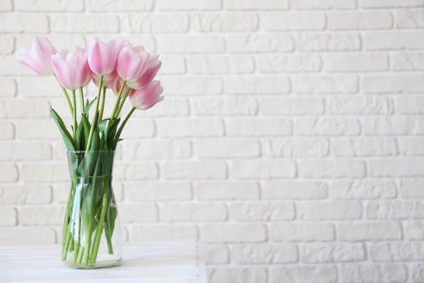 istock Lofty interior with flowers in glass vase on the table. 1144377596